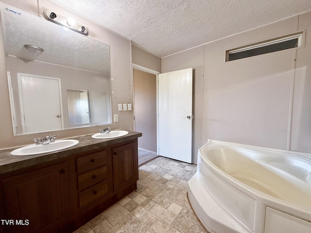 943 Newman Hollow Rd, Bean Station, TN 37708 - full bath with double vanity, a garden tub, stone finish flooring, and a textured ceiling