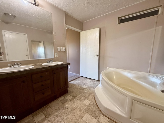 943 Newman Hollow Rd, Bean Station, TN 37708 - full bathroom with double vanity, a garden tub, a textured ceiling, and stone finish floors