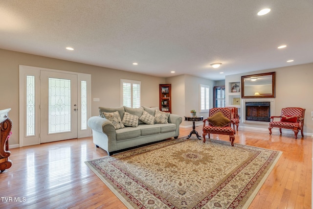 19275 Wyndale Rd, Abingdon, VA 24210 - living area featuring a textured ceiling, light wood-style flooring, recessed lighting, and a fireplace with raised hearth