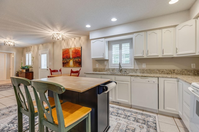 19275 Wyndale Rd, Abingdon, VA 24210 - kitchen with dishwasher, light tile patterned floors, white cabinets, a textured ceiling, and recessed lighting