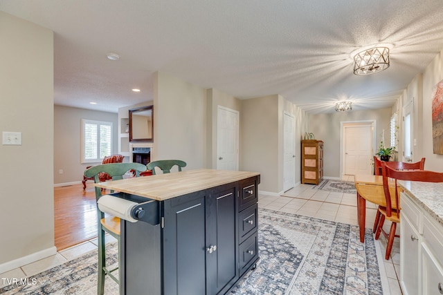 19275 Wyndale Rd, Abingdon, VA 24210 - kitchen featuring light tile patterned floors, recessed lighting, a textured ceiling, open floor plan, and wooden counters