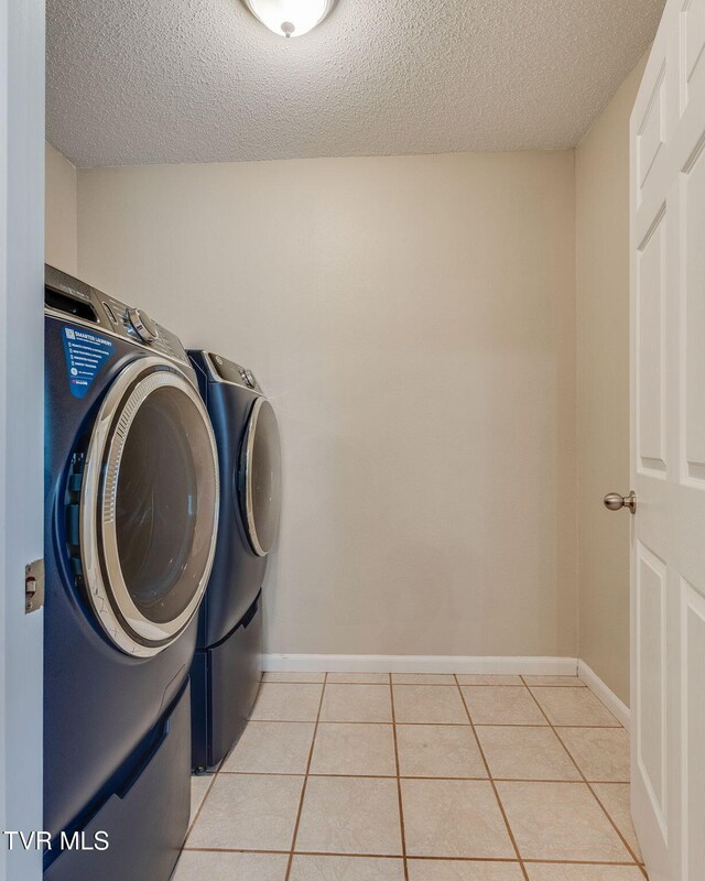 19275 Wyndale Rd, Abingdon, VA 24210 - laundry room featuring washer and clothes dryer, a textured ceiling, and light tile patterned flooring