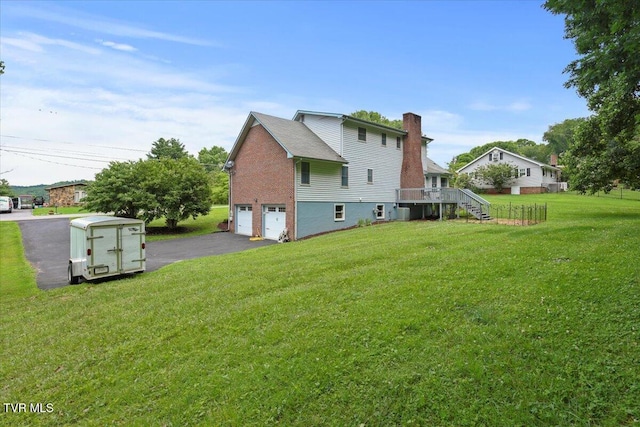 377 Overlook Dr, Blountville, TN 37617 - back of property with a chimney, an attached garage, stairway, asphalt driveway, and brick siding