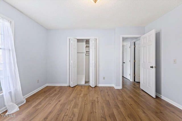 377 Overlook Dr, Blountville, TN 37617 - unfurnished bedroom with wood finished floors, a closet, and a textured ceiling