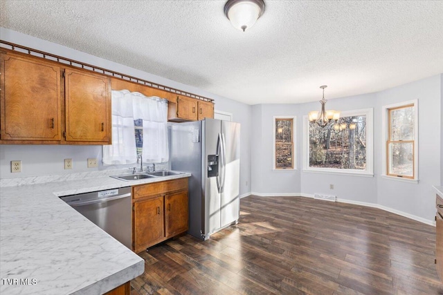 377 Overlook Dr, Blountville, TN 37617 - kitchen with appliances with stainless steel finishes, brown cabinets, a chandelier, light countertops, and a textured ceiling
