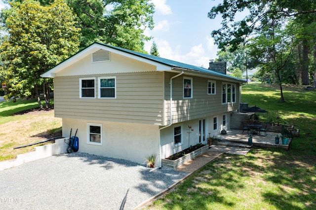 101 Ridgewood Dr, Bristol, TN 37620 - back of property with a chimney, a lawn, stucco siding, and a patio area