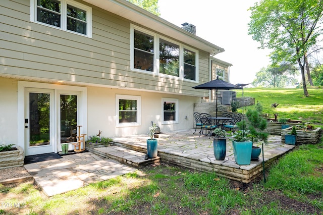 101 Ridgewood Dr, Bristol, TN 37620 - rear view of house with a patio, a chimney, a yard, and stucco siding