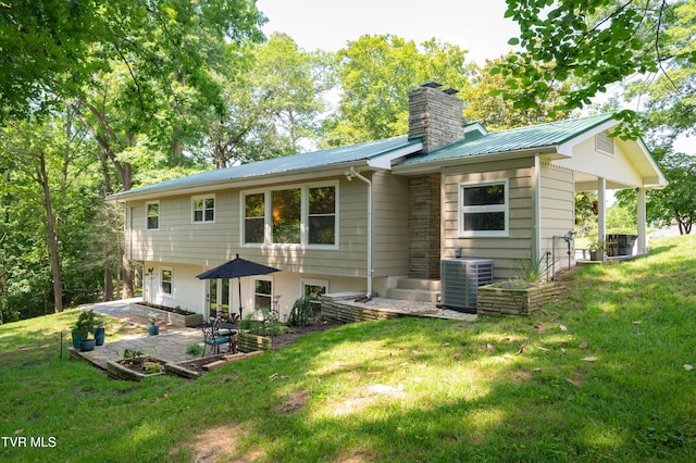 101 Ridgewood Dr, Bristol, TN 37620 - back of property featuring a chimney, a patio, a lawn, and a metal roof