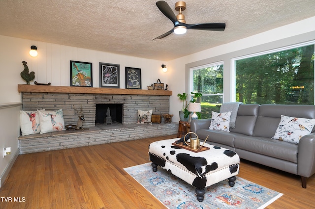 101 Ridgewood Dr, Bristol, TN 37620 - living room with a textured ceiling, wood finished floors, a ceiling fan, and a fireplace