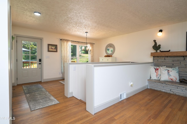 101 Ridgewood Dr, Bristol, TN 37620 - entrance foyer featuring a textured ceiling, a chandelier, light wood finished floors, and healthy amount of natural light