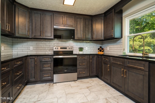 101 Ridgewood Dr, Bristol, TN 37620 - kitchen with stainless steel appliances, dark brown cabinets, backsplash, a textured ceiling, and light marble finish floors
