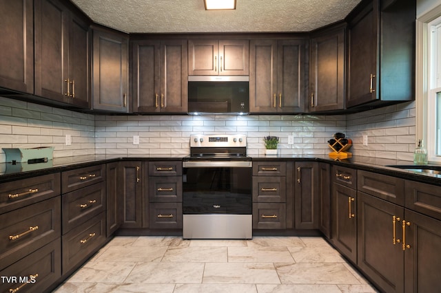 101 Ridgewood Dr, Bristol, TN 37620 - kitchen featuring stainless steel appliances, dark brown cabinets, a textured ceiling, tasteful backsplash, and light marble finish floors