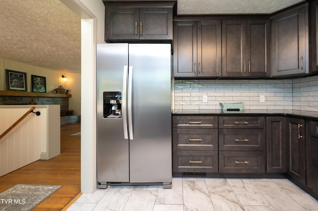 101 Ridgewood Dr, Bristol, TN 37620 - kitchen with stainless steel refrigerator with ice dispenser, a textured ceiling, dark brown cabinets, tasteful backsplash, and dark countertops