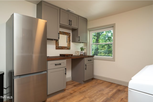 101 Ridgewood Dr, Bristol, TN 37620 - kitchen with freestanding refrigerator, gray cabinets, light wood-style floors, and butcher block countertops