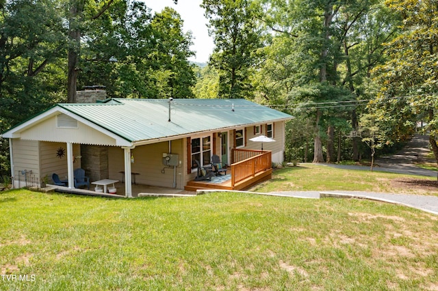 101 Ridgewood Dr, Bristol, TN 37620 - rear view of property featuring a yard, a metal roof, a ceiling fan, and a chimney