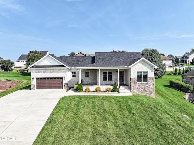 150 Naples Ln, Greeneville, TN 37745 - view of front facade with a porch, concrete driveway, a front yard, brick siding, and roof with shingles