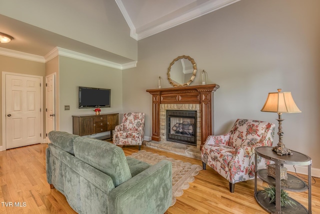 3 Chestnut Ridge Ct, Jonesborough, TN 37659 - living area with ornamental molding, light wood-style floors, vaulted ceiling, and a fireplace with raised hearth