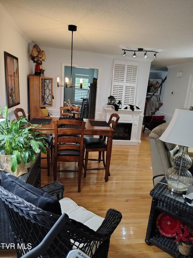 400 Sunset Dr Unit L56, Johnson City, TN 37604 - living room with crown molding, light wood finished floors, stairway, a textured ceiling, and a fireplace