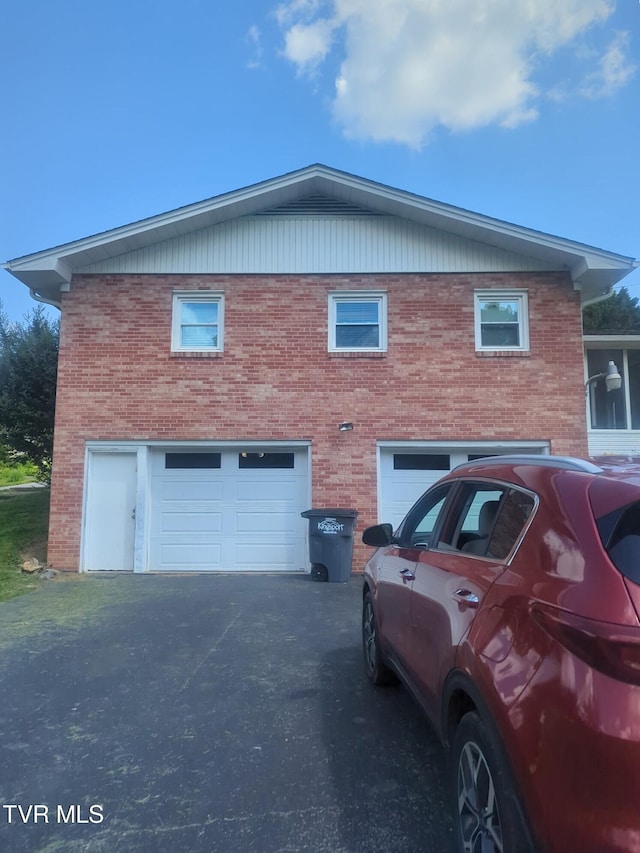 233 Pioneer Haven Ln, Kingsport, TN 37663 - view of side of property with driveway, an attached garage, and brick siding