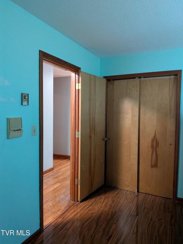 233 Pioneer Haven Ln, Kingsport, TN 37663 - unfurnished bedroom featuring wood finished floors, a closet, and a textured ceiling