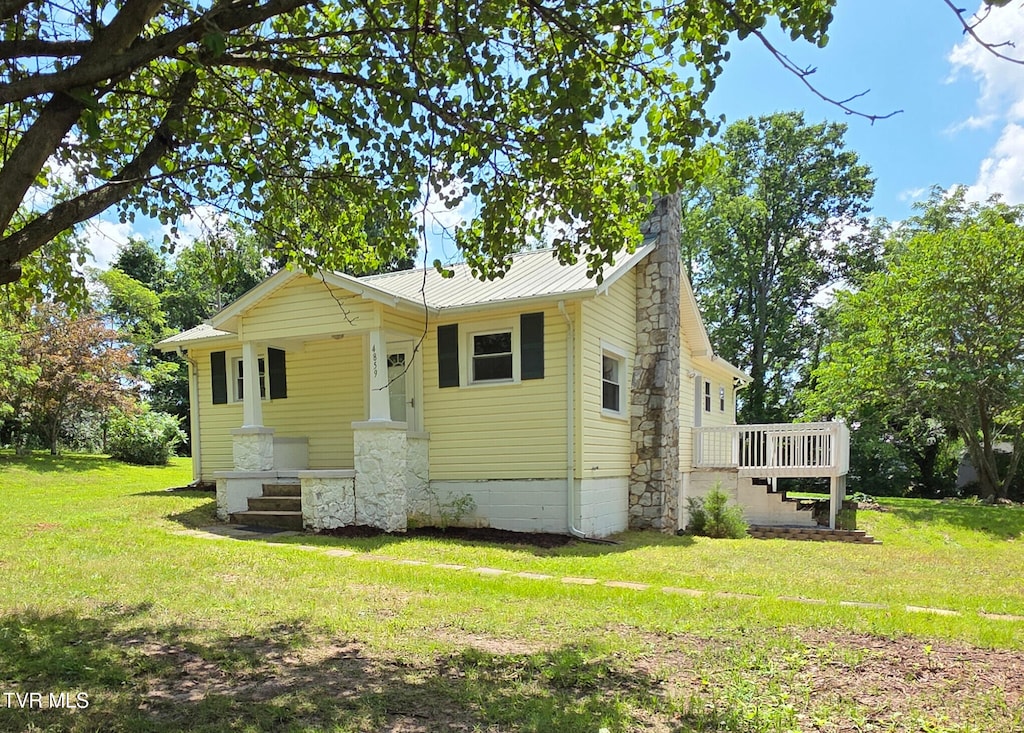 4859 Bluff City Hwy, Bluff City, TN 37618 - bungalow-style house with a front yard, a chimney, and a metal roof
