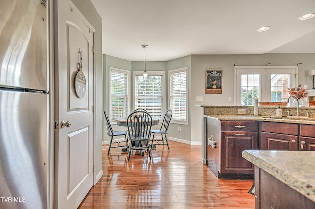 517 W Glade St, Glade Spring, VA 24340 - kitchen with freestanding refrigerator, healthy amount of natural light, light wood-style floors, recessed lighting, and light stone counters