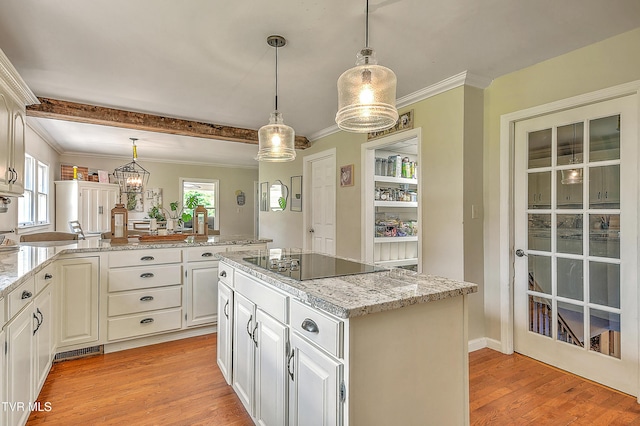 22643 Twin Oaks Rd, Abingdon, VA 24211 - kitchen with black electric stovetop, light wood-style flooring, a kitchen island, pendant lighting, and light stone countertops