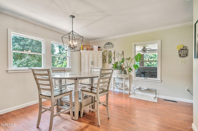 22643 Twin Oaks Rd, Abingdon, VA 24211 - dining area with healthy amount of natural light, crown molding, a chandelier, and light wood-style flooring