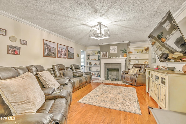 22643 Twin Oaks Rd, Abingdon, VA 24211 - living area with ornamental molding, a textured ceiling, light wood finished floors, a chandelier, and a tile fireplace