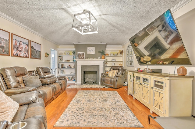 22643 Twin Oaks Rd, Abingdon, VA 24211 - living area with light wood-style flooring, a textured ceiling, a tiled fireplace, ornamental molding, and built in features