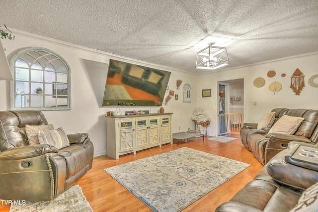 22643 Twin Oaks Rd, Abingdon, VA 24211 - living room featuring crown molding, a textured ceiling, a chandelier, and light wood-type flooring