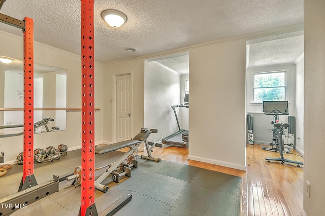 22643 Twin Oaks Rd, Abingdon, VA 24211 - workout area featuring wood finished floors, a textured ceiling, and ornamental molding