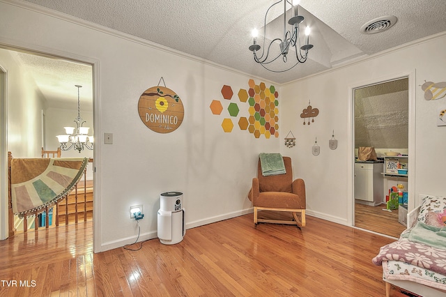22643 Twin Oaks Rd, Abingdon, VA 24211 - living area with a chandelier, a textured ceiling, ornamental molding, and light wood finished floors