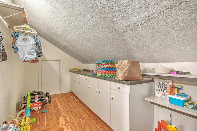 22643 Twin Oaks Rd, Abingdon, VA 24211 - laundry area with a textured ceiling and light wood-style floors