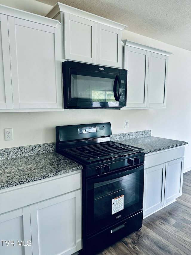 1461 Gress Mag Mtn, Kingsport, TN 37660 - kitchen featuring black appliances, dark wood-style flooring, dark stone counters, and white cabinets