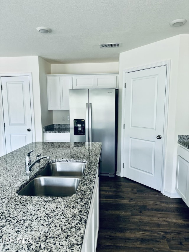 1461 Gress Mag Mtn, Kingsport, TN 37660 - kitchen with dark wood finished floors, stone counters, white cabinetry, stainless steel refrigerator with ice dispenser, and a textured ceiling