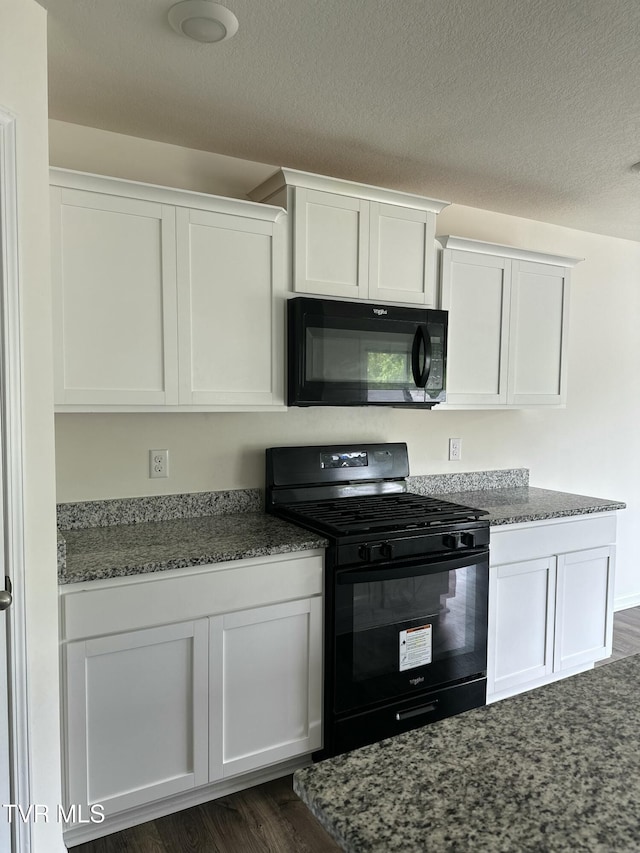 1461 Gress Mag Mtn, Kingsport, TN 37660 - kitchen featuring black appliances, white cabinets, dark stone counters, dark wood-style floors, and a textured ceiling