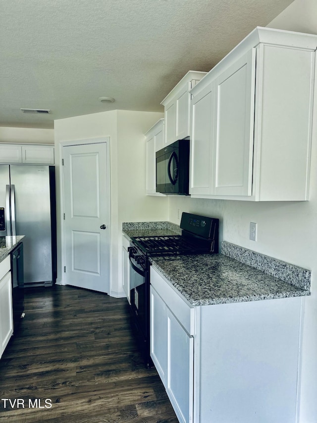 1461 Gress Mag Mtn, Kingsport, TN 37660 - kitchen featuring black appliances, white cabinets, stone countertops, dark wood-type flooring, and a textured ceiling