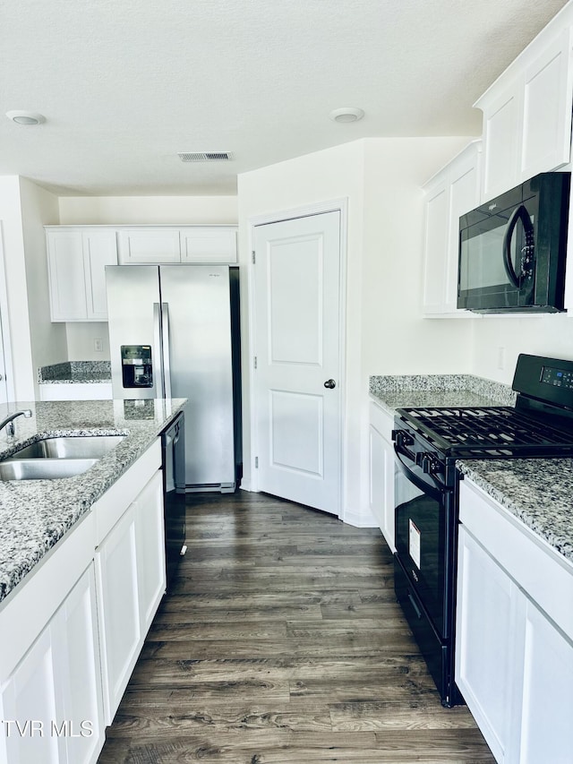 1461 Gress Mag Mtn, Kingsport, TN 37660 - kitchen with black appliances, white cabinetry, dark wood-style flooring, and light stone counters