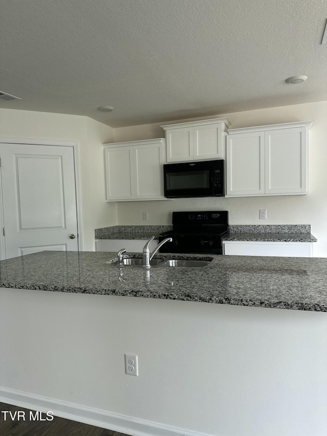 1461 Gress Mag Mtn, Kingsport, TN 37660 - kitchen with black appliances, white cabinetry, dark stone counters, and a textured ceiling