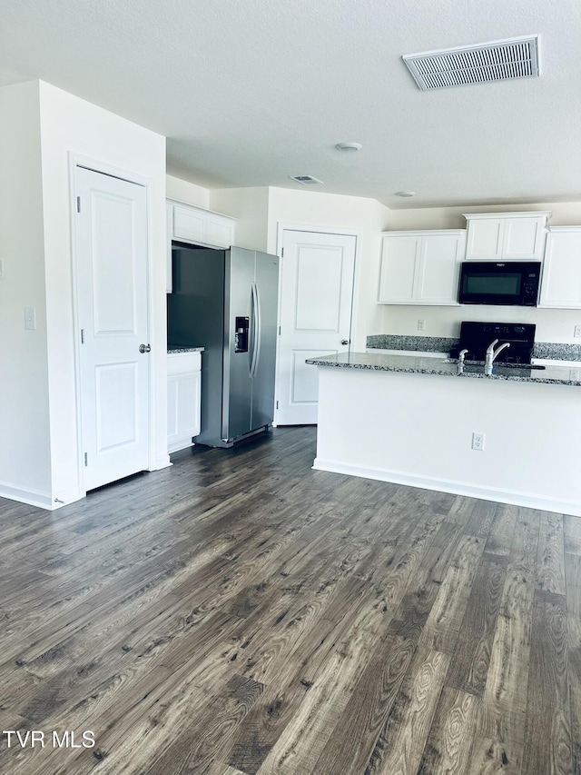 1461 Gress Mag Mtn, Kingsport, TN 37660 - kitchen with black microwave, stainless steel fridge, white cabinets, dark wood finished floors, and dark stone countertops