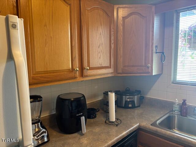 1145 Carriage Cir Unit 204, Bristol, VA 24201 - kitchen featuring white fridge and backsplash