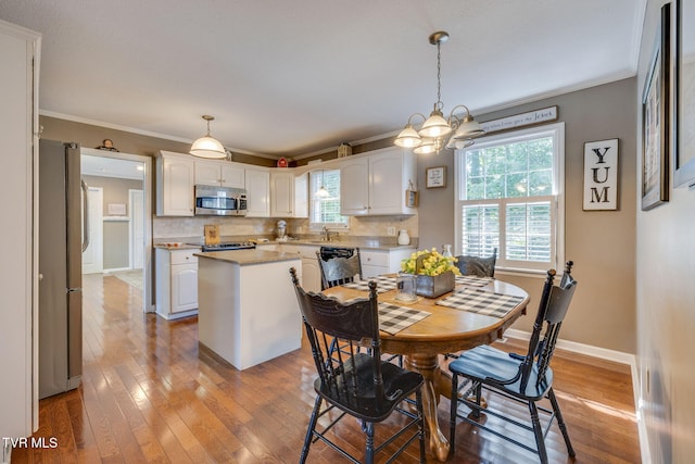 5116 Waterford Dr, Kingsport, TN 37664 - dining area with crown molding, light wood-style floors, plenty of natural light, and a chandelier