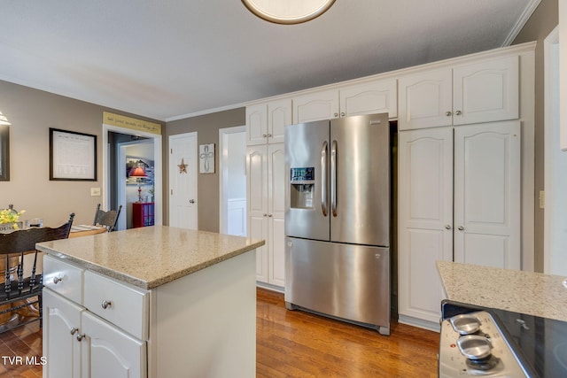 5116 Waterford Dr, Kingsport, TN 37664 - kitchen with stainless steel refrigerator with ice dispenser, wood finished floors, white cabinetry, ornamental molding, and a center island