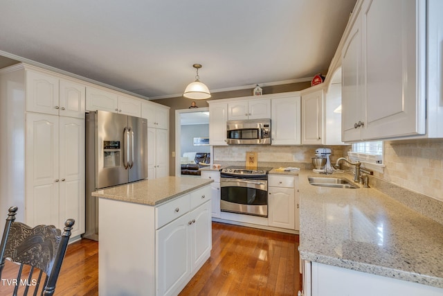 5116 Waterford Dr, Kingsport, TN 37664 - kitchen with appliances with stainless steel finishes, ornamental molding, white cabinets, tasteful backsplash, and light stone counters