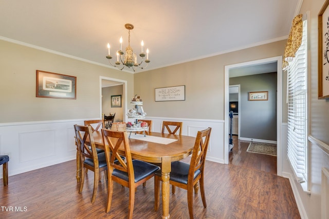 5116 Waterford Dr, Kingsport, TN 37664 - dining space featuring a chandelier, dark wood-type flooring, a wainscoted wall, crown molding, and a decorative wall