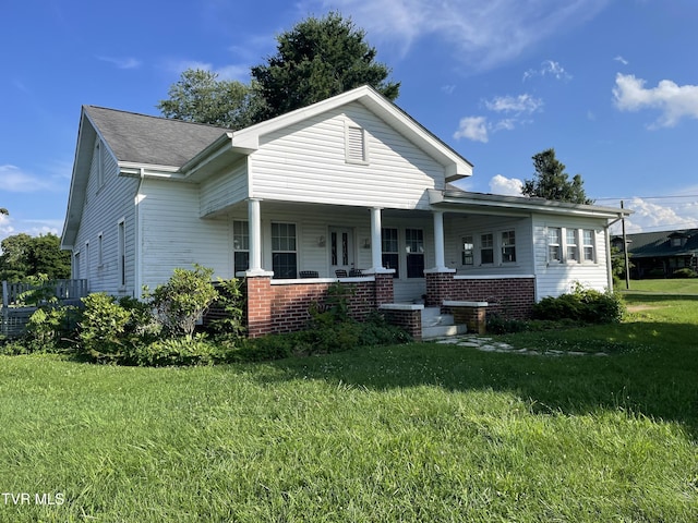 2572 May Rd, Talbott, TN 37877 - view of front of house featuring covered porch, a front lawn, brick siding, and a shingled roof