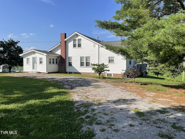 2572 May Rd, Talbott, TN 37877 - view of side of home with a yard, driveway, and a chimney