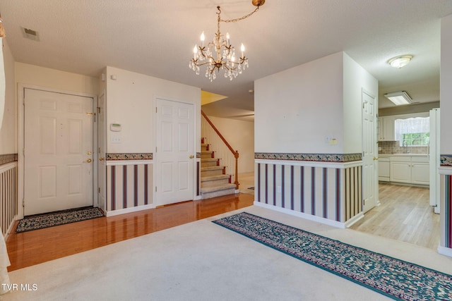 811 Fain Ave Unit 811, Kingsport, TN 37660 - entryway featuring light wood finished floors, stairs, a chandelier, and light colored carpet