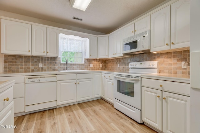 811 Fain Ave Unit 811, Kingsport, TN 37660 - kitchen featuring white appliances, light countertops, white cabinets, light wood-style flooring, and a textured ceiling